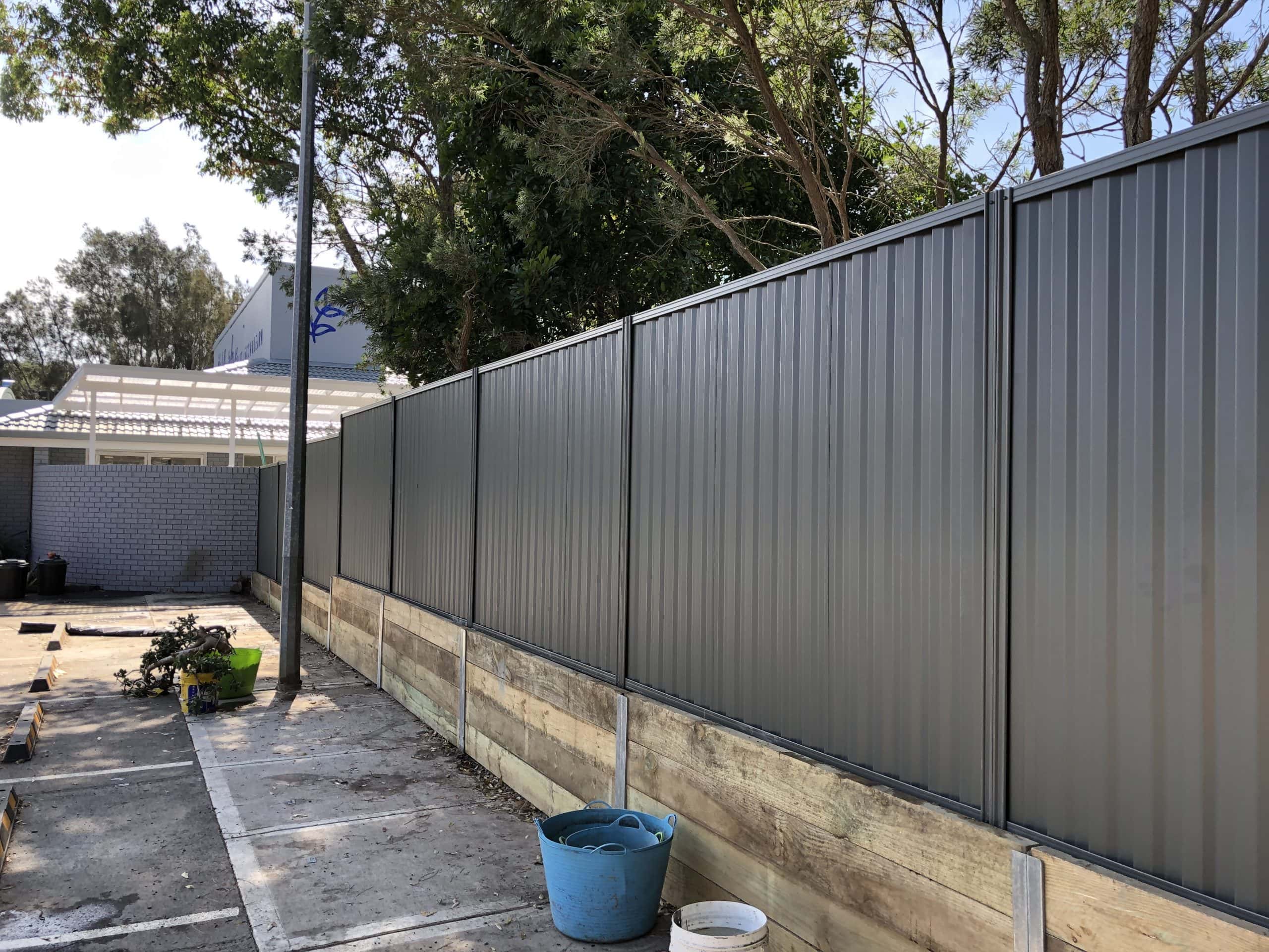 Genuine BlueScope Colorbond boundary fence in a modern charcoal finish installed by Master Groups.