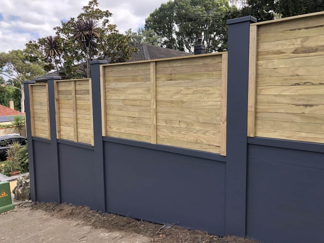 Modern wooden fence with dark blue base and natural timber panels in NSW.