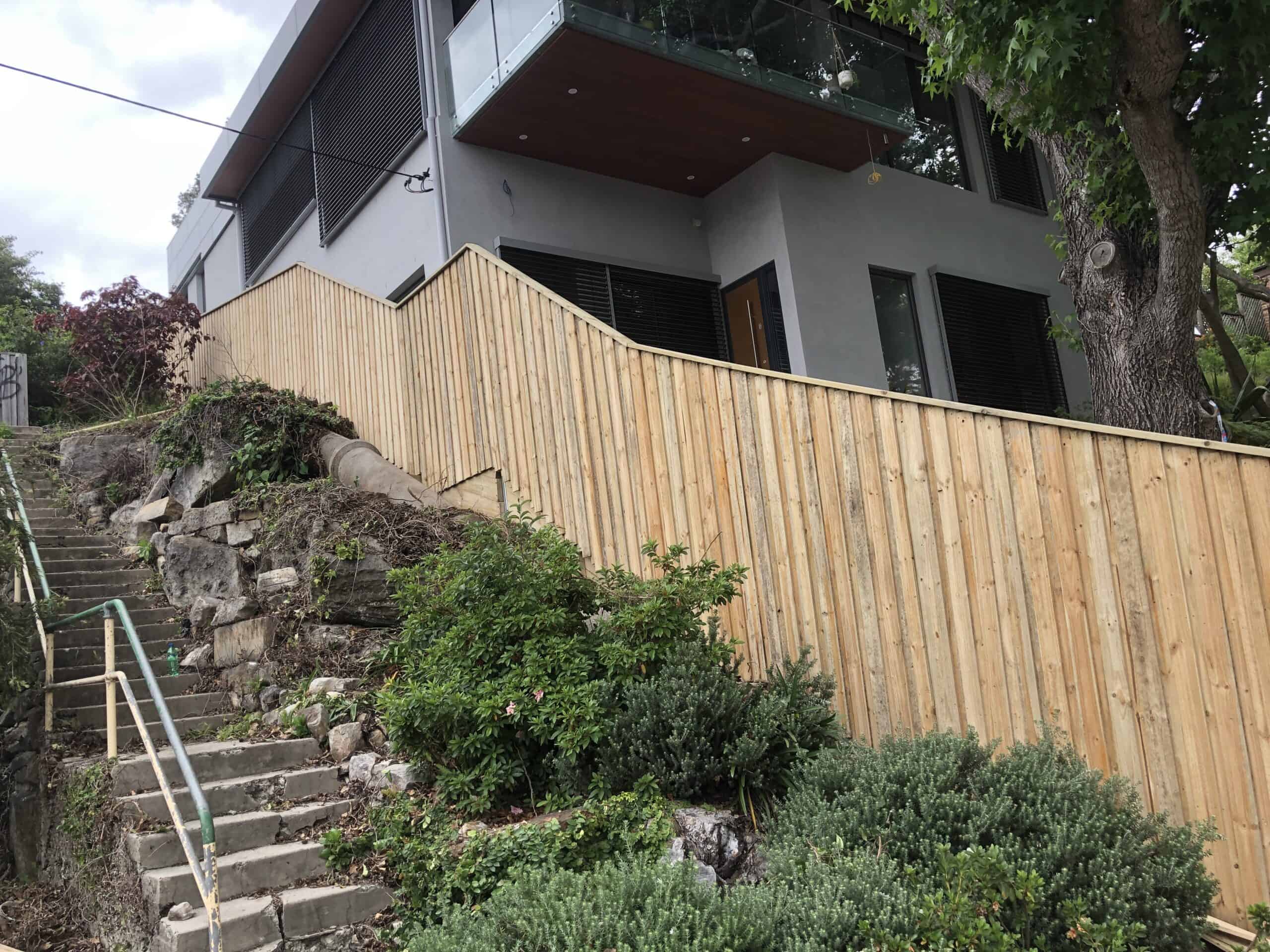 Double lapped treated pine paling fence on a sloping block in Mount Kuring-gai by master groups
